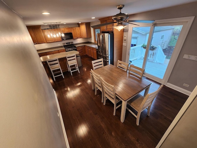 dining area with ceiling fan and dark wood-type flooring