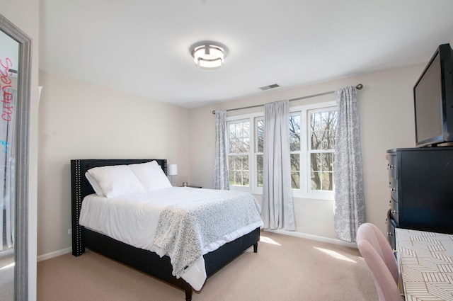 bedroom featuring light colored carpet