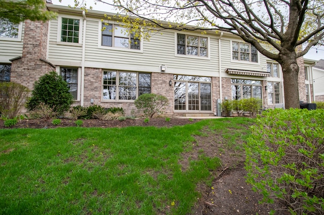 rear view of property with a yard