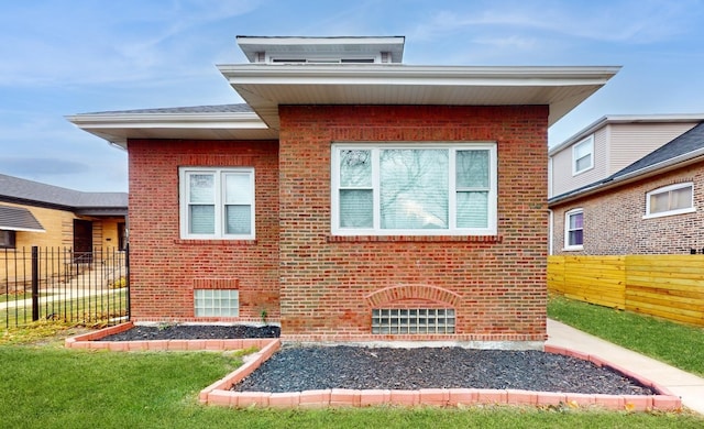 rear view of property featuring a lawn