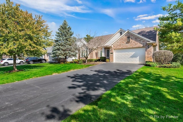 view of front of house with a front yard and a garage