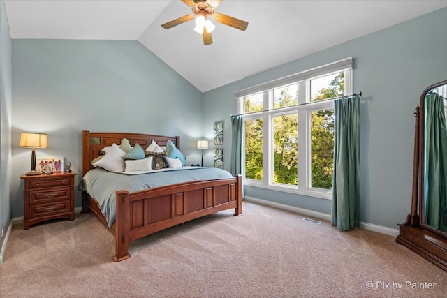 bedroom with ceiling fan, light colored carpet, and lofted ceiling