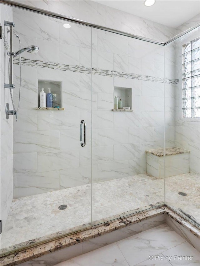 bathroom with a shower with shower door