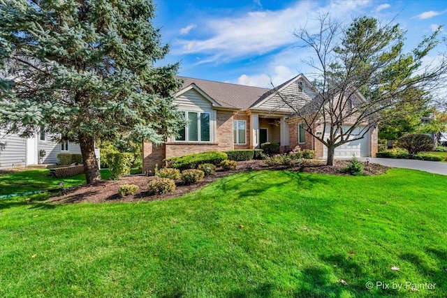 view of front of house featuring a garage and a front lawn