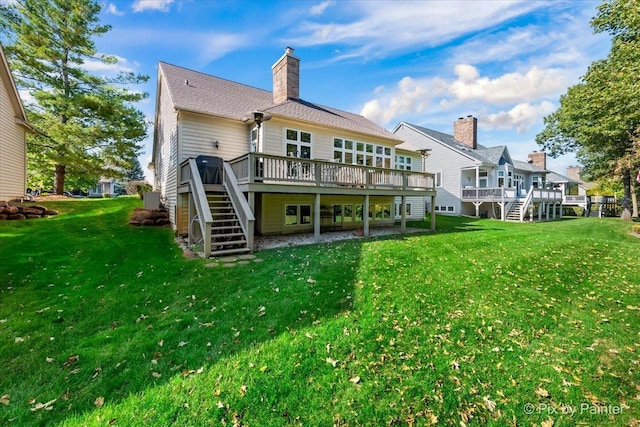 back of property with a deck and a yard