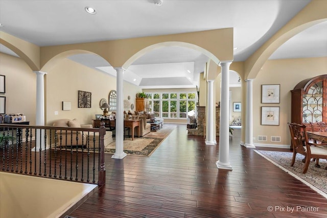 entrance foyer with dark hardwood / wood-style flooring and a tray ceiling