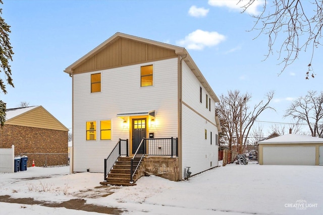 view of front of house with a garage and an outdoor structure