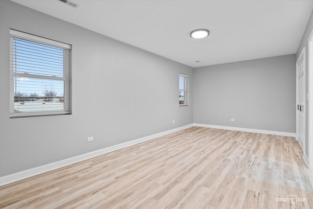 spare room with light hardwood / wood-style floors