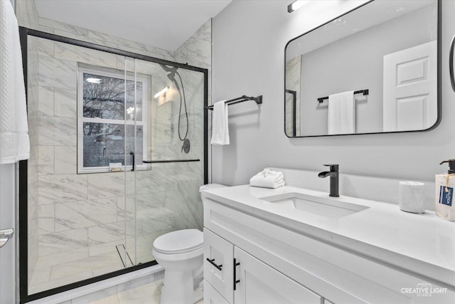 bathroom featuring toilet, vanity, and walk in shower