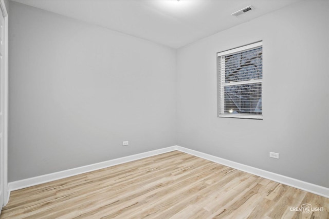 spare room featuring light wood-type flooring