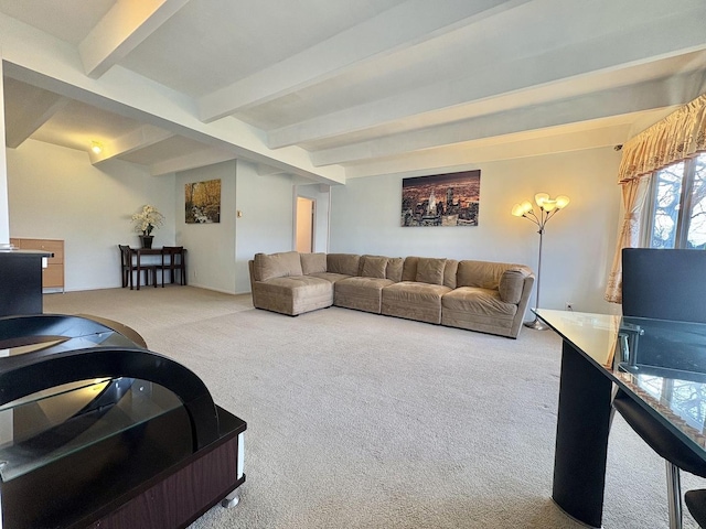 carpeted living room with beamed ceiling