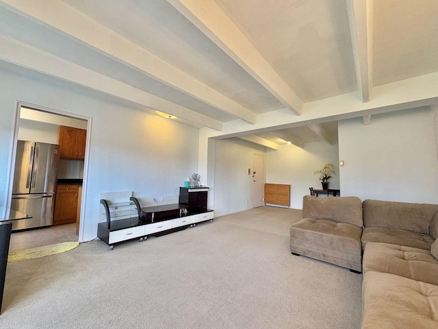 living room featuring beamed ceiling and carpet flooring