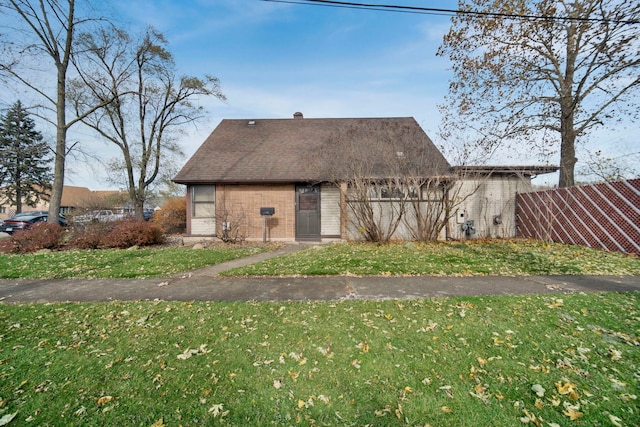 back of house with a lawn