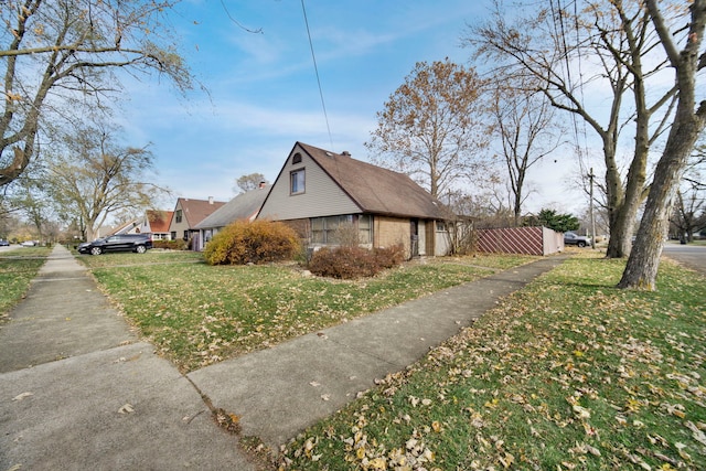 view of side of home with a lawn