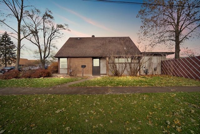 back house at dusk with a yard