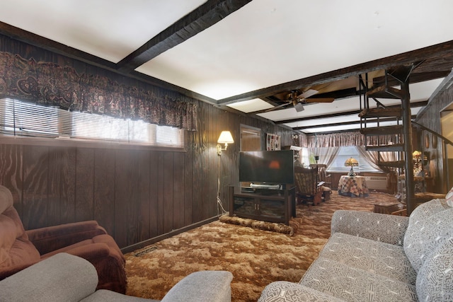 living room featuring beamed ceiling, a wealth of natural light, and ceiling fan