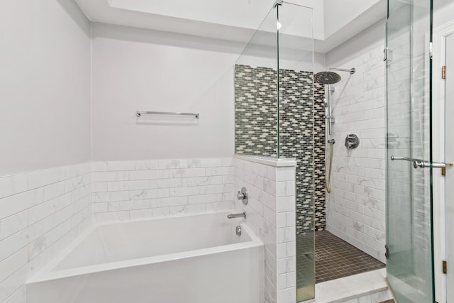 bathroom with separate shower and tub