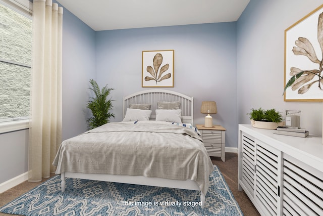 bedroom with dark colored carpet