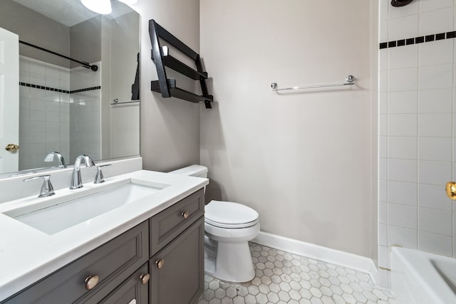 bathroom featuring tile patterned flooring, vanity, and toilet