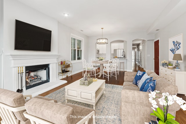 living room with hardwood / wood-style floors and an inviting chandelier