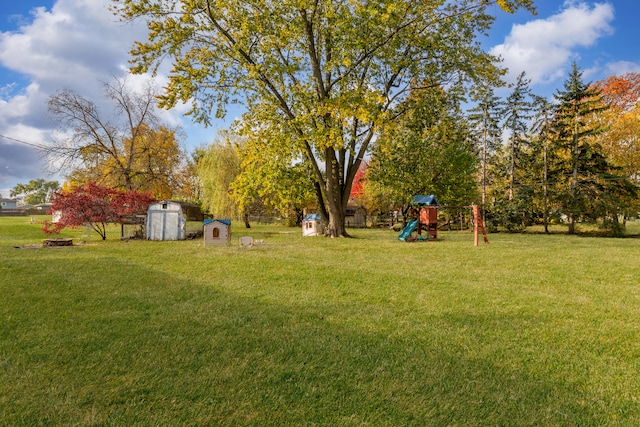 view of yard featuring a playground and a shed