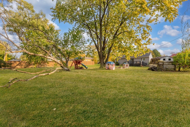 view of yard featuring a playground and a shed