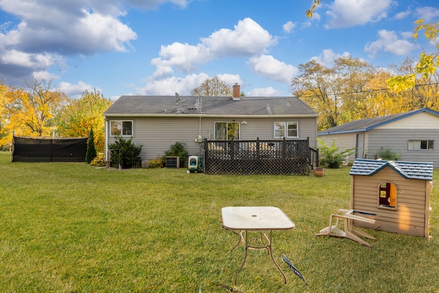 back of house featuring a deck and a lawn