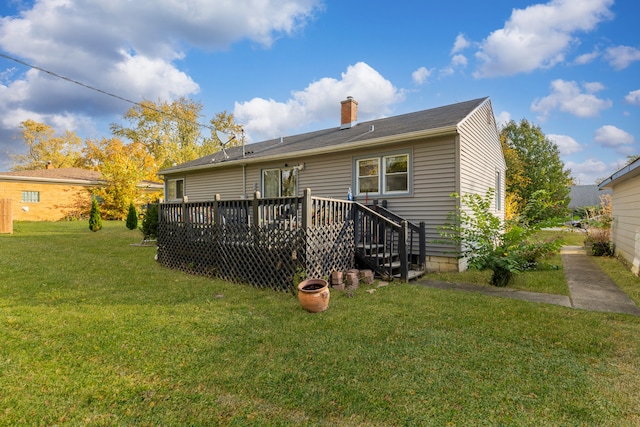 back of house with a deck and a yard