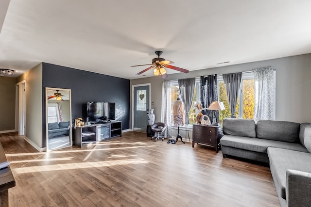 living room with ceiling fan and hardwood / wood-style floors