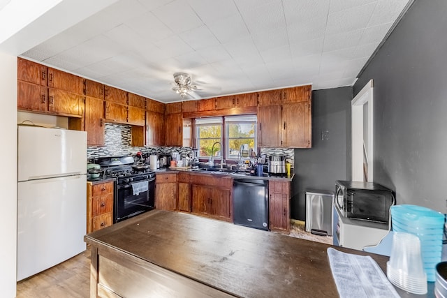 kitchen with ceiling fan, sink, tasteful backsplash, light hardwood / wood-style flooring, and black appliances