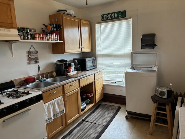 kitchen with white range with gas cooktop, washer / clothes dryer, sink, and exhaust hood