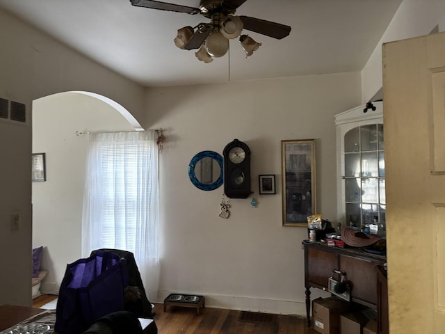 interior space with ceiling fan and dark wood-type flooring