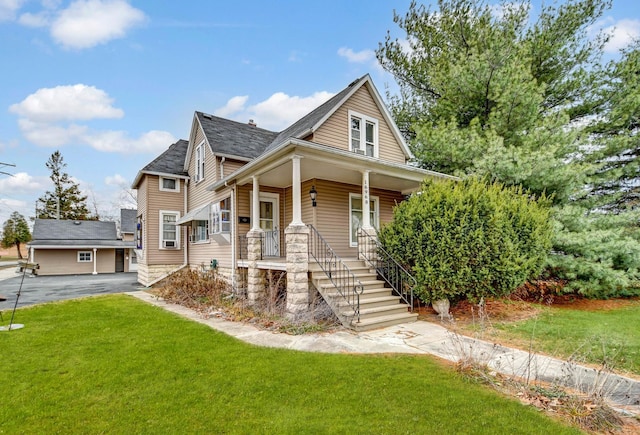 view of front of house featuring a front yard and a porch