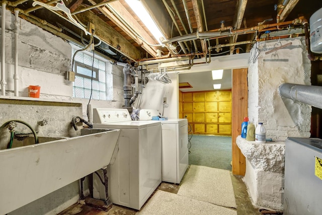 clothes washing area featuring separate washer and dryer and sink