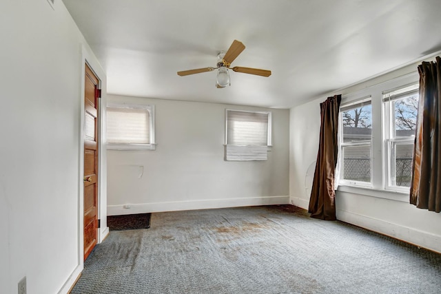 spare room featuring carpet and ceiling fan