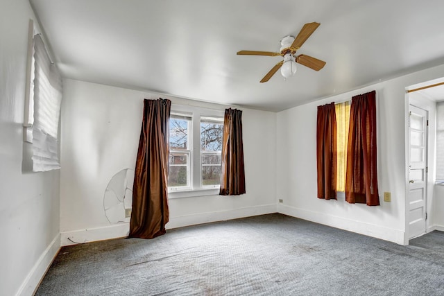 unfurnished room featuring ceiling fan and dark colored carpet