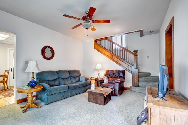 carpeted living room with ceiling fan