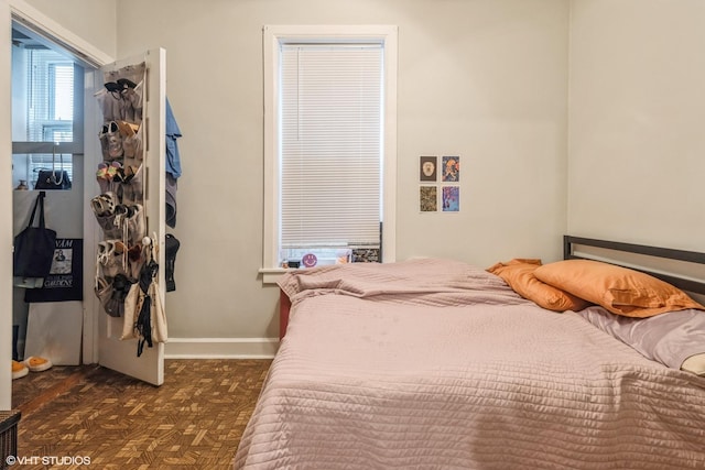 bedroom with dark parquet flooring