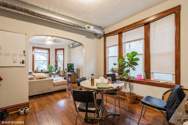 dining space with ceiling fan and wood-type flooring