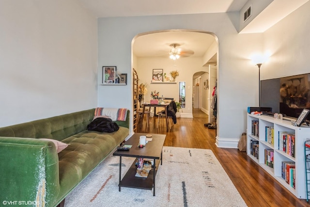 living room with hardwood / wood-style flooring and ceiling fan