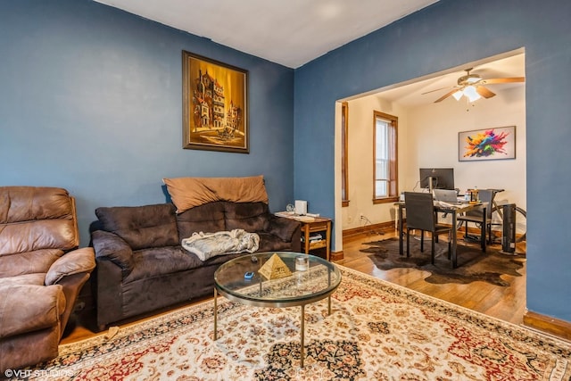 living room featuring hardwood / wood-style floors and ceiling fan