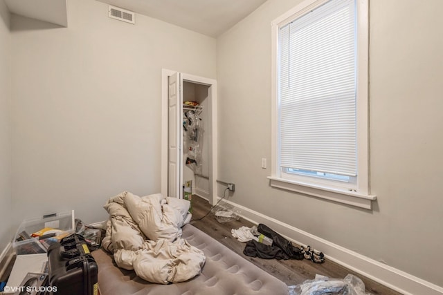 interior space with multiple windows and hardwood / wood-style flooring