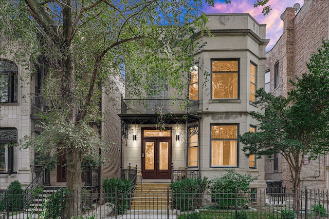 view of front of property with french doors and a balcony