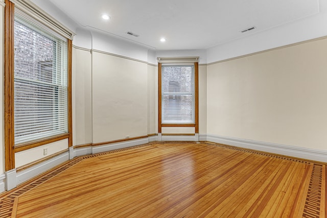 spare room with wood-type flooring