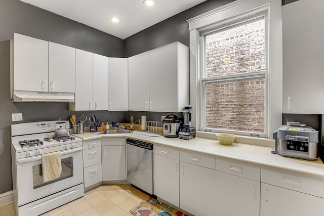 kitchen with white range with gas stovetop, white cabinetry, dishwasher, and sink