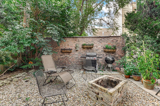 view of patio / terrace featuring an outdoor fire pit and a grill