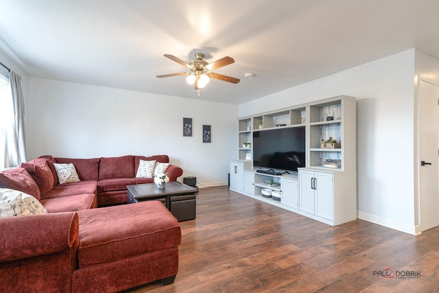 living room featuring ceiling fan and dark wood-type flooring