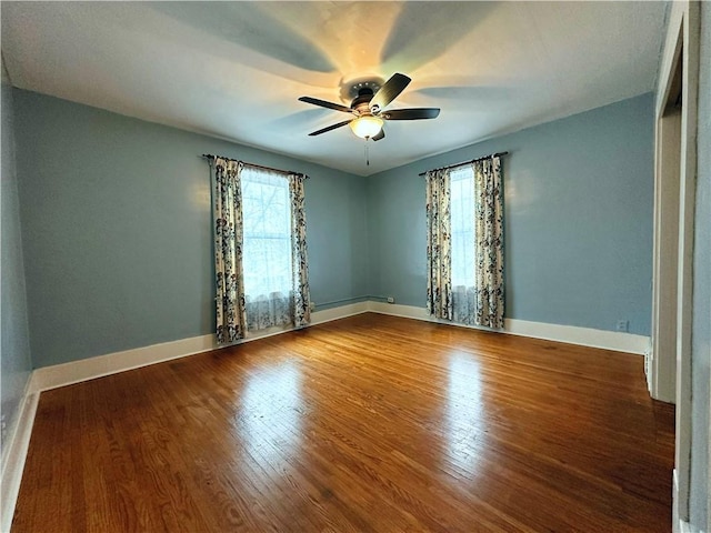 empty room featuring hardwood / wood-style flooring and ceiling fan