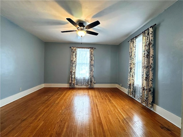 spare room featuring wood-type flooring and ceiling fan