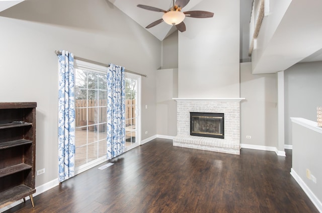 unfurnished living room with ceiling fan, a fireplace, high vaulted ceiling, and wood-type flooring